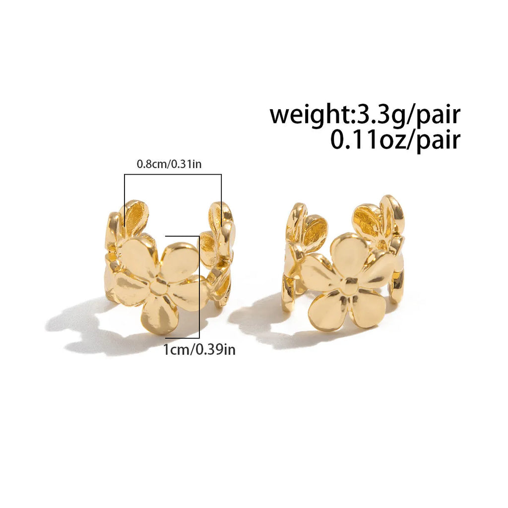 Gold-coloured drop earrings with a detailed starfish and conch shell design on a white background.