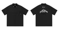 Man's black loose-fit pocket shirt with embroidery and half sleeves on a hanger.