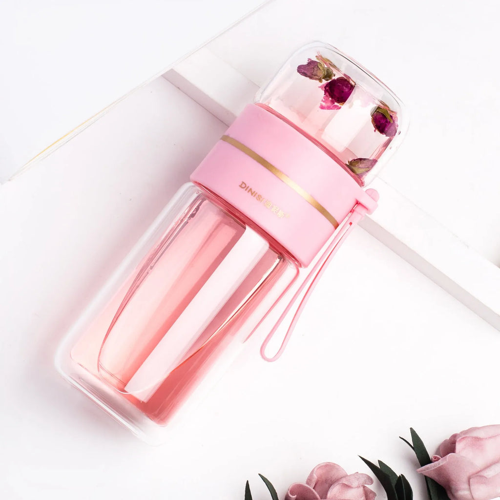 Double-wall glass water bottle with tea infuser insert and rope handle in assorted colours.