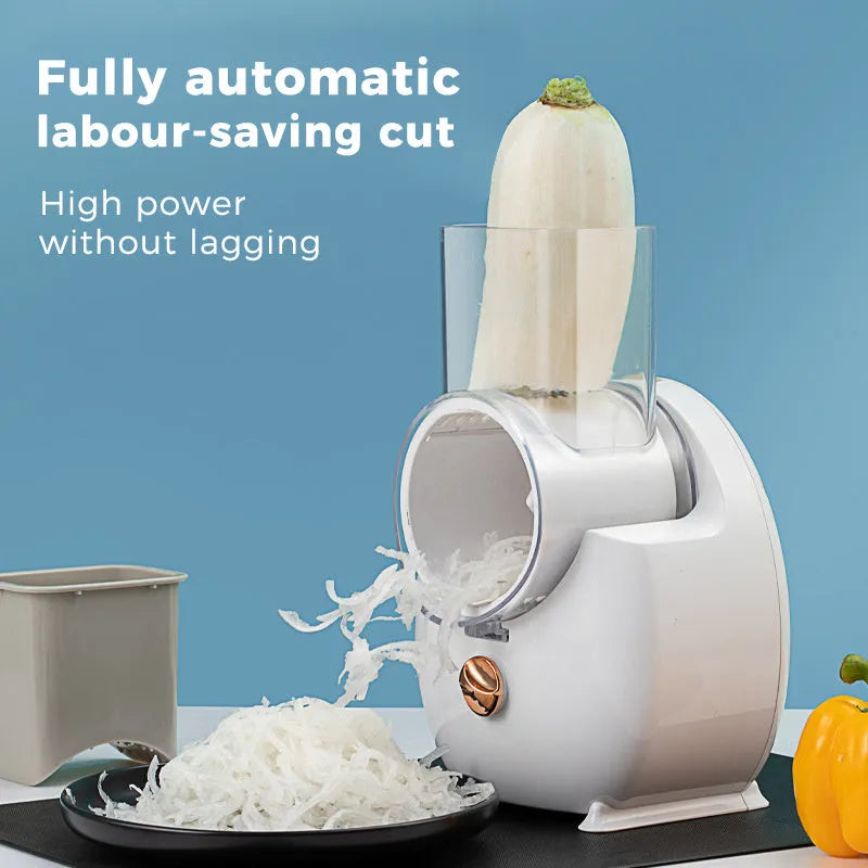 White electric vegetable slicer with rotary grater, suction base, and multiple blades on a kitchen counter.