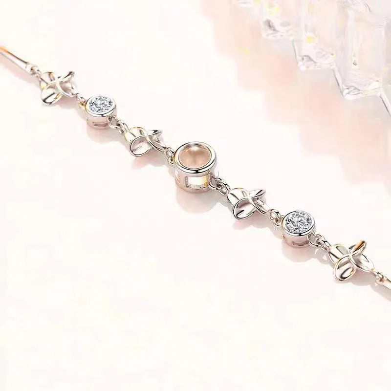 Women's sterling silver projection photo bracelet with white leaf and flower design and diamond-cut finish