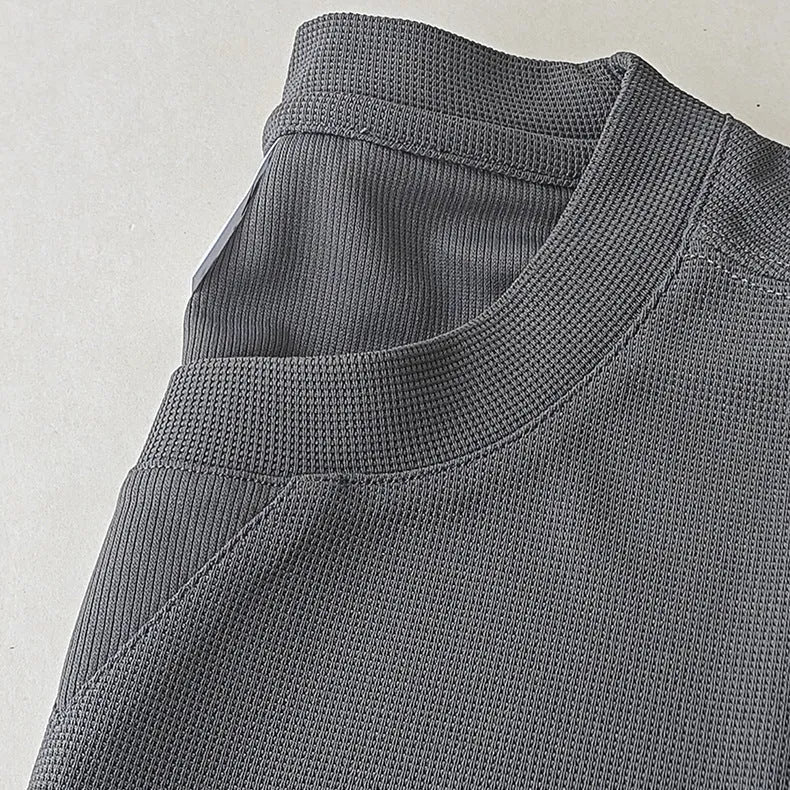 Men's dark grey heavyweight waffle knit short-sleeved T-shirt on a hanger.