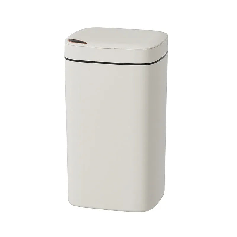 Automatic sensor bin with square white body and open induction lid on a kitchen floor.