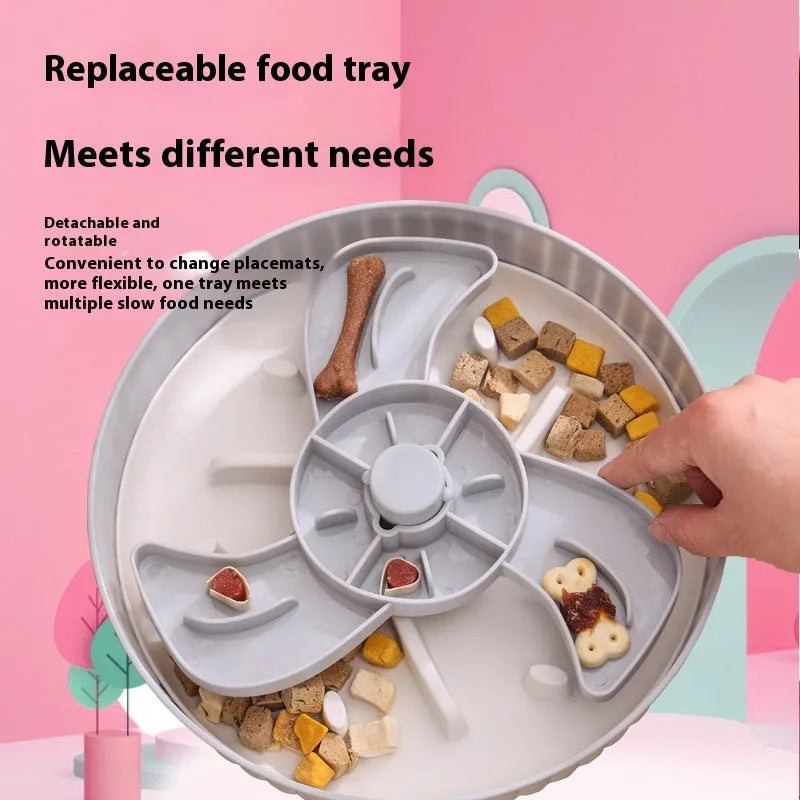 Grey pet slow feeder bowl with rotating windmill-pattern top and a white anti-choke silicone pad in the centre.