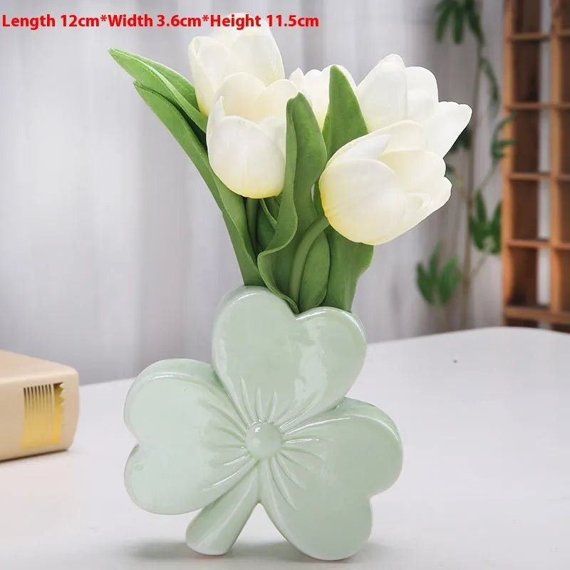 Clover white porcelain ceramic vase in European style on a desk.