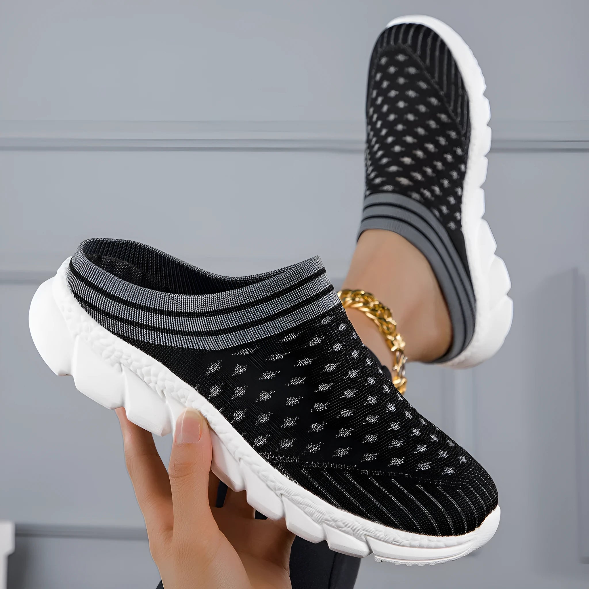 Women's Flyknit slipper shoes in a stripe pattern, showing hollowed-out design and sewing lines, on a viscose sole.