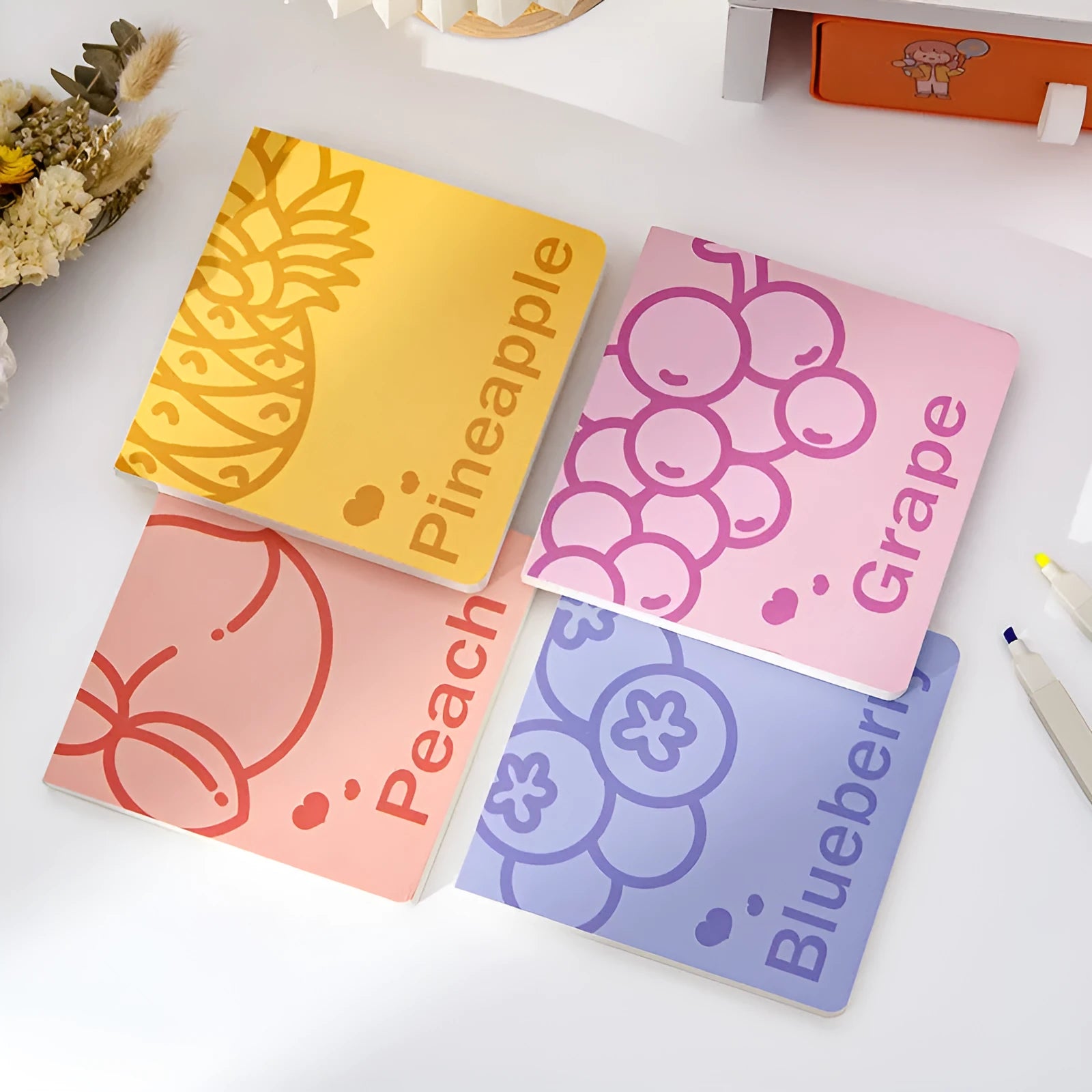 Square notebook with embossed fruit design on cover, showing 14.5cm size and open pages.