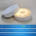 Compact white motion-activated USB rechargeable LED night light with adhesive tape.