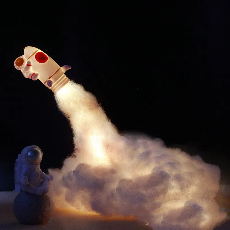 DIY astronaut rocket LED night light kit with battery and USB options, showing model parts and warm glow.