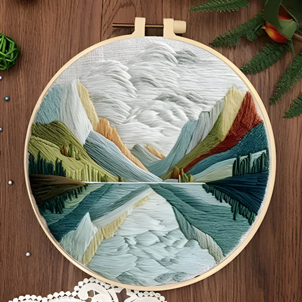 Embroidery DIY kit with landscape-printed cotton fabric, embroidery threads, and needles for handmade cloth art