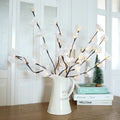 Pink silk orchid LED branch light, 65cm long, with glowing warm white LEDs on fabric petals and plastic stem.