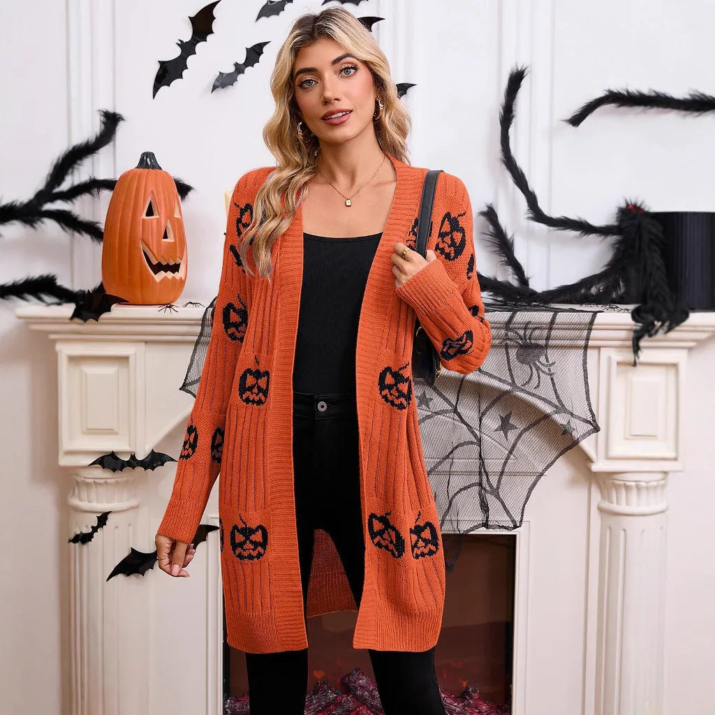 Women's black knitted cardigan with an orange jacquard pumpkin head pattern on the front.