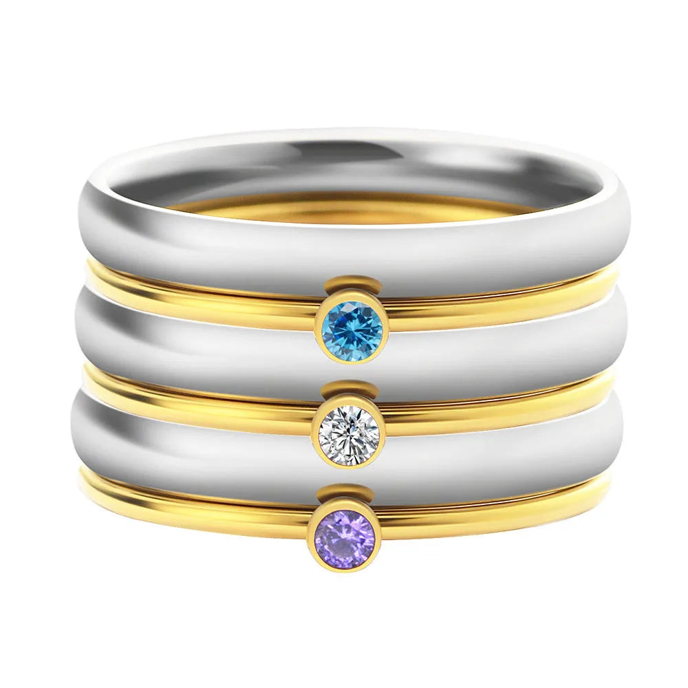 Gold tone titanium steel ring with a December birthstone in an engraved geometric design.