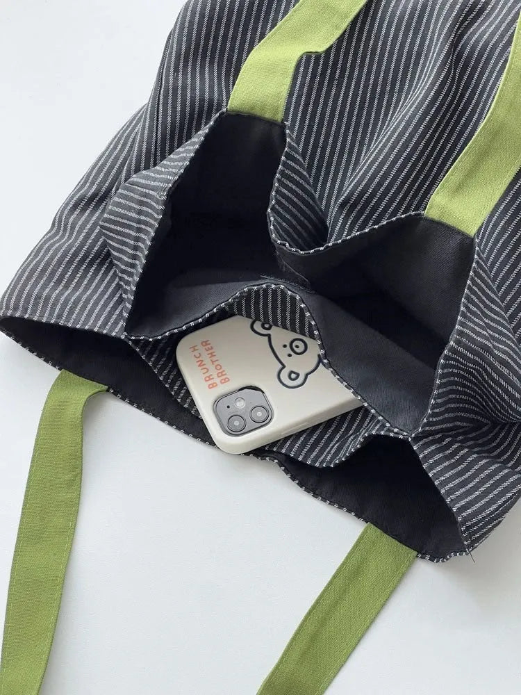 Cotton canvas multi-layer tote shoulder bag in plaid or striped pattern options with wide straps.
