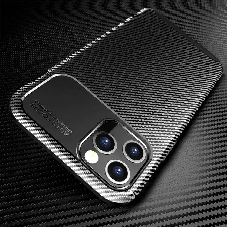 Black silicone protective phone case for iPhone 12 on a table.