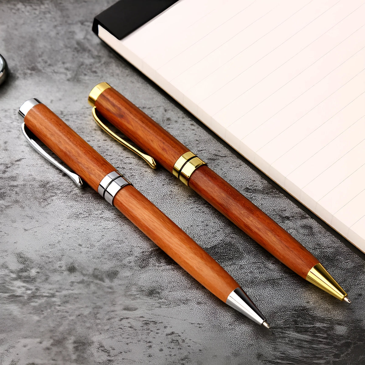 Gold metal and rosewood rollerball pen on a desk, 14cm long