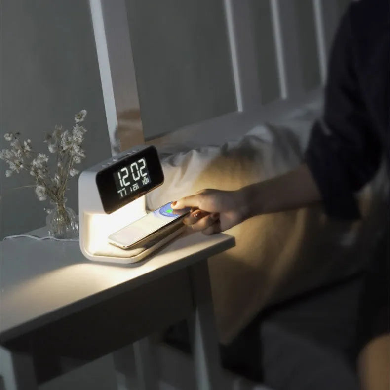 White 3-in-1 bedside lamp with wireless charging pad, LCD alarm clock display, and touch controls.