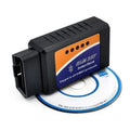 Small black ELM327 Bluetooth OBD2 diagnostic scanner plugged into a car's port.