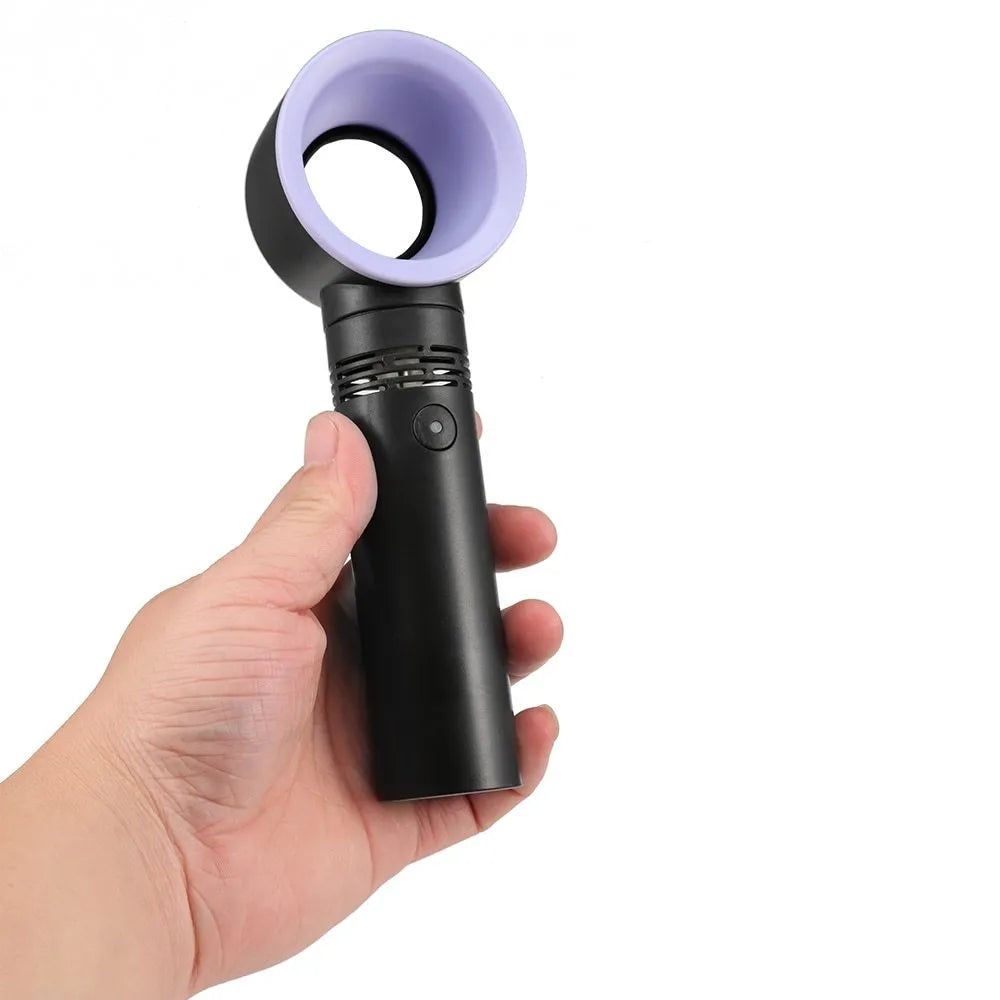 A compact portable bladeless fan with USB cable on a desk.