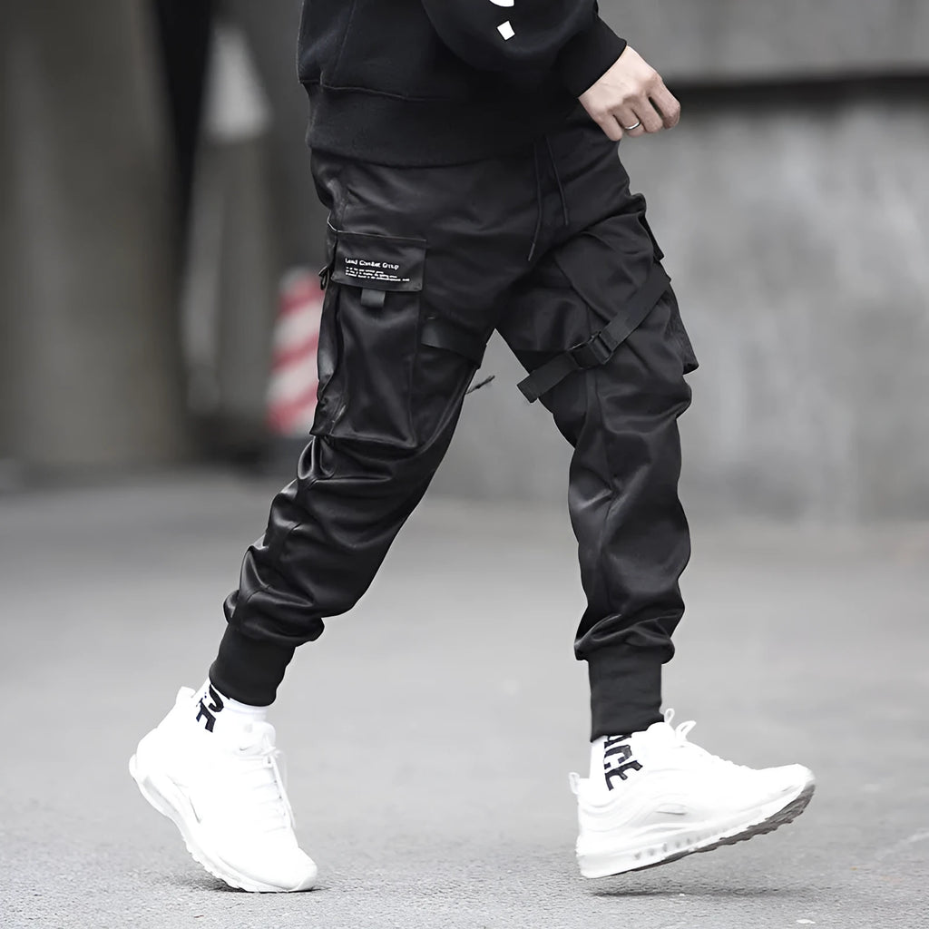 Black 100% cotton overall trousers with tapered leg, front view, on a plain background.
