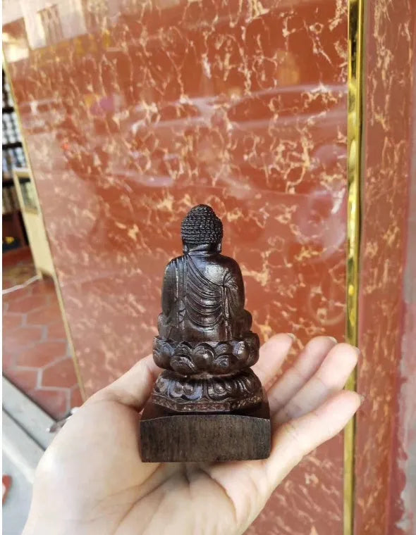 Hand-carved Sakyamuni Buddha statue in natural black wood, 30cm tall, for home or office display