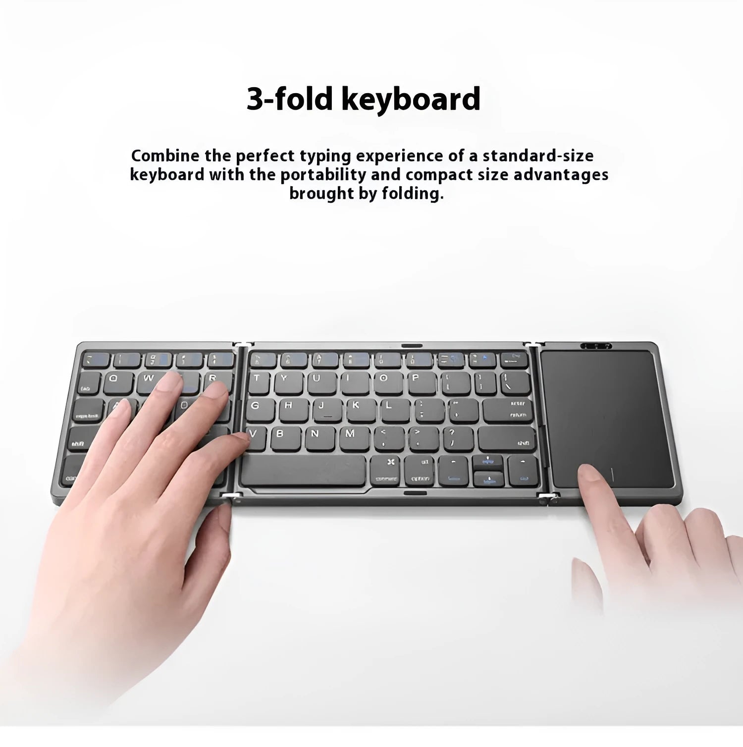 Three folding wireless Bluetooth keyboard with touch pad in black, unfolded on a desk