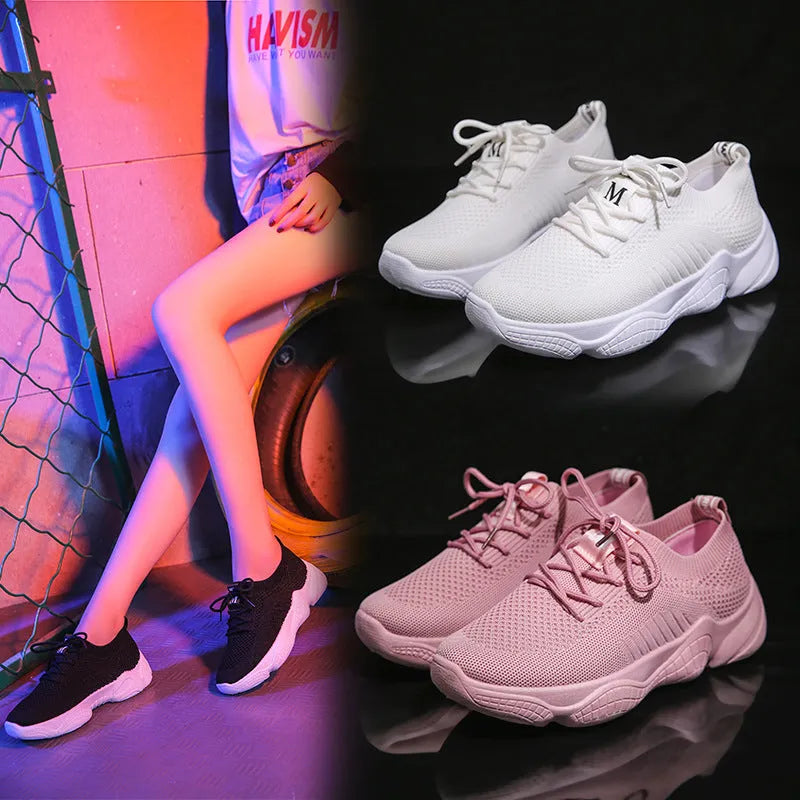 Women's white fly-knit sports shoes with thick rubber sole and front strap.
