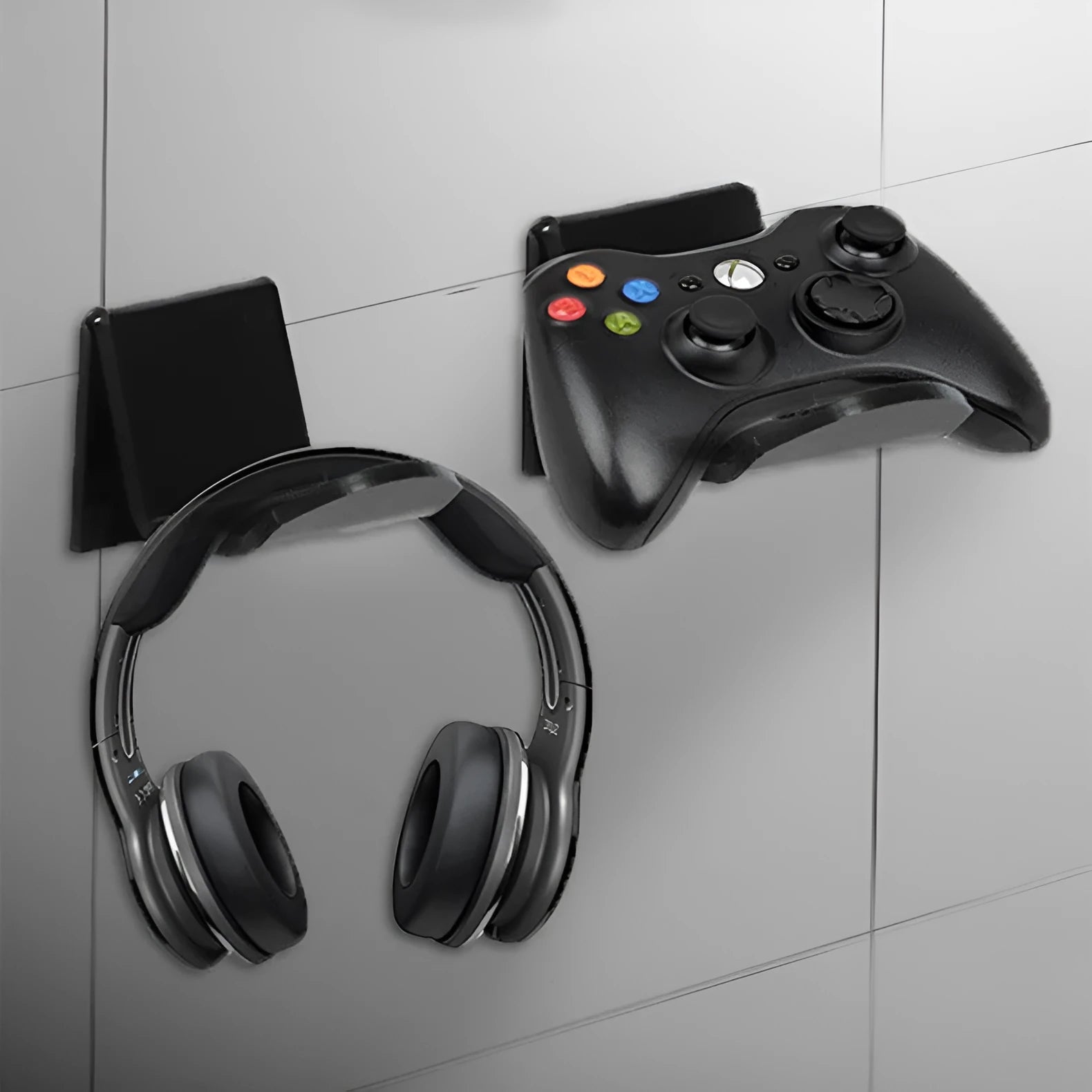 Universal plastic game controller bracket in black colour showing mounting points for installation