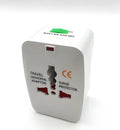 Universal travel plug adapter showing UK, US, EU, and AU pins with dimensions 73x50x39 mm.