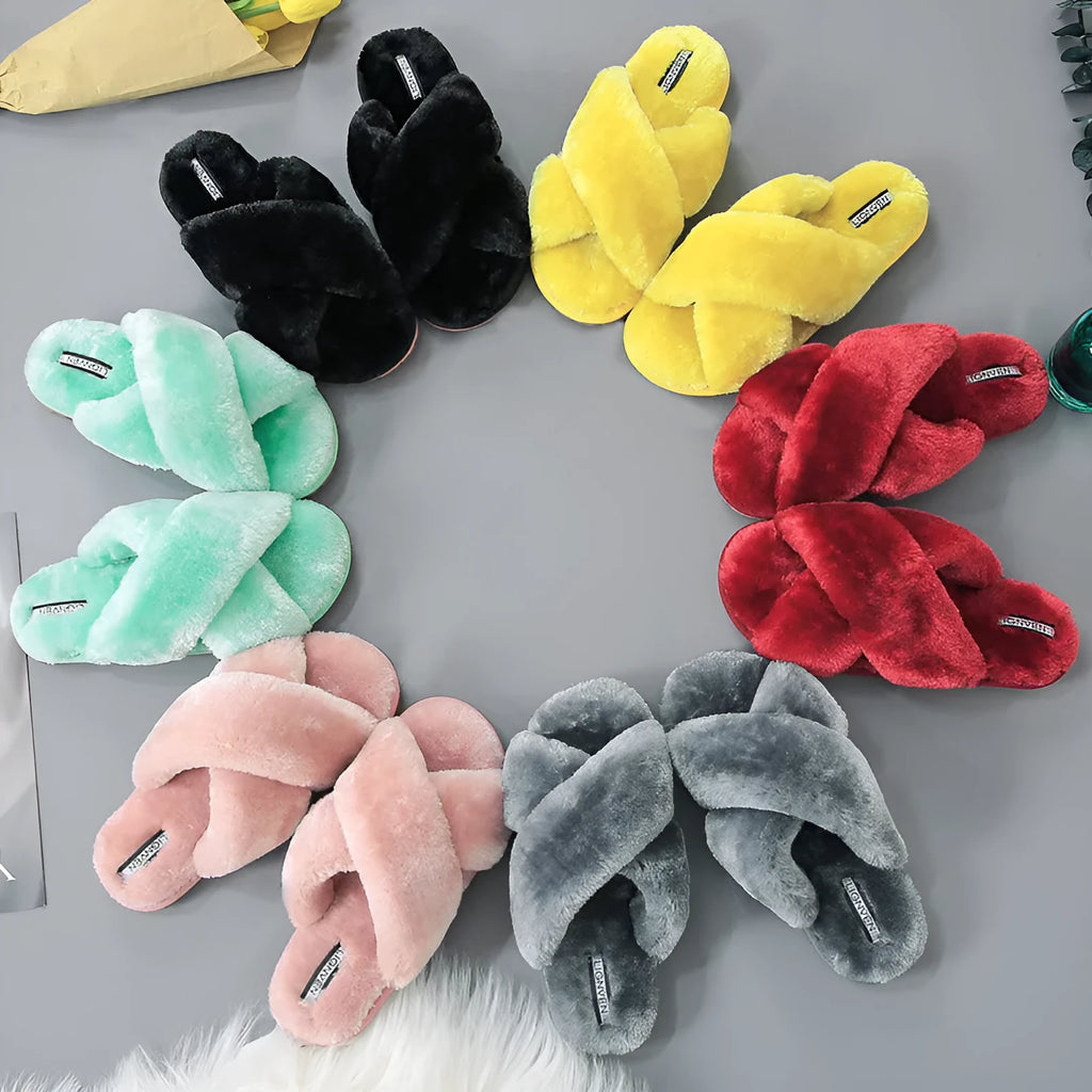 Women's black cross open-toe fur slippers with a textured sole on a light background.