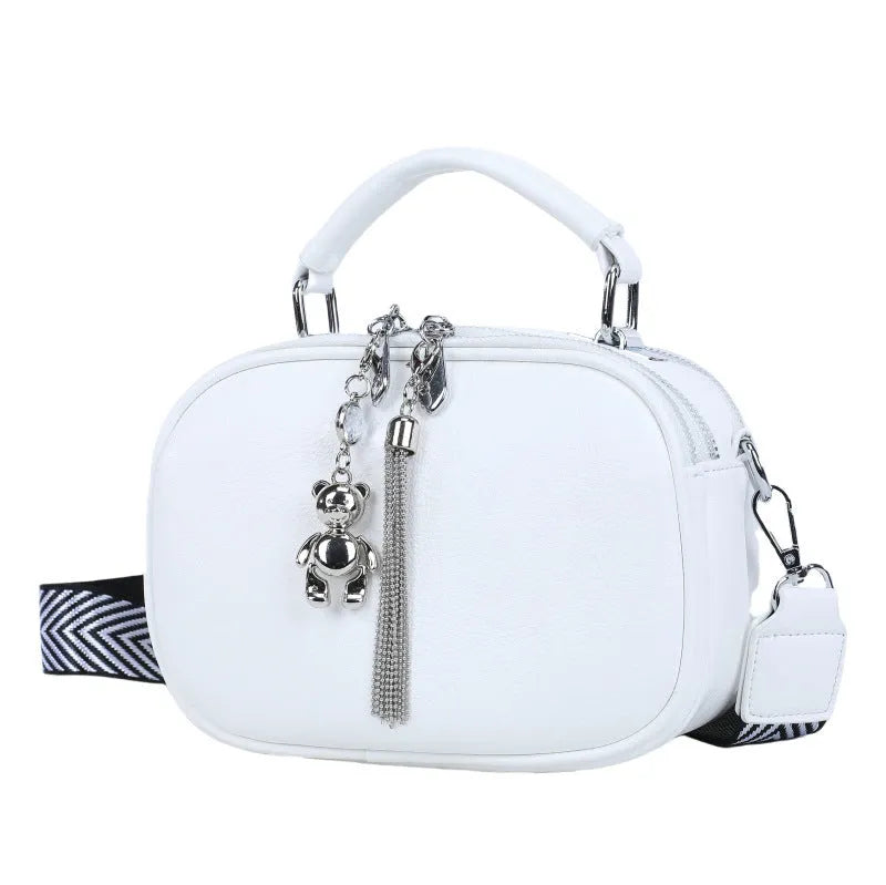 Oval-shaped women's small square bag in soft PU leather with double strap, shown in multiple colours.