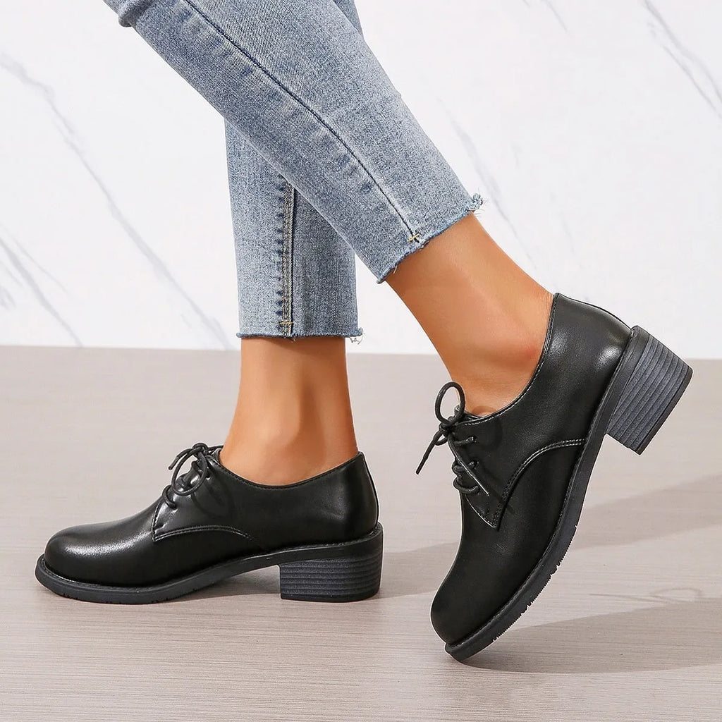 Black women's work shoes with a chunky heel, round toe, and low top design on a rubber sole.