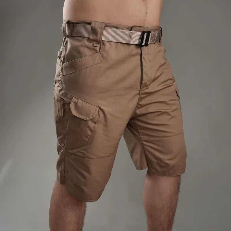 IX7 men's tactical shorts in cotton blend fabric, shown in a camouflage colour with button-fly closure.