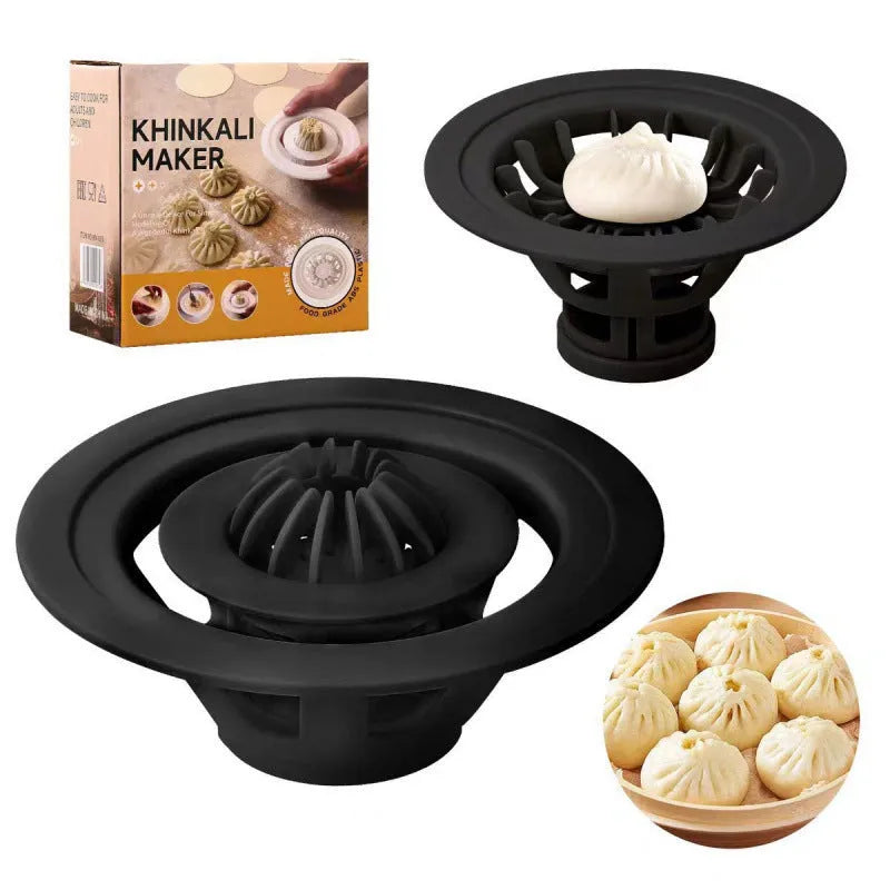 Set of four black plastic steamed bun and dumpling shaping moulds on a kitchen surface.