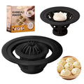 Set of four black plastic steamed bun and dumpling shaping moulds on a kitchen surface.