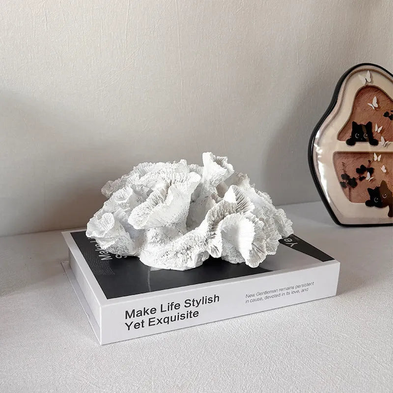 Off-white geometry coral ornament made from synthetic resin on a shelf
