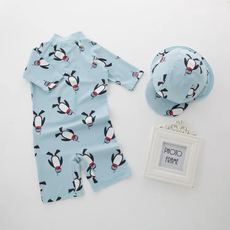 Boy's penguin print long sleeve swim shirt and matching cap set for sun protection.