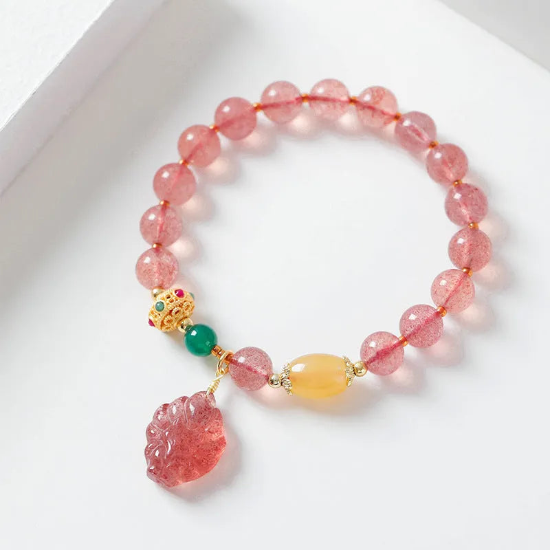 Close-up of a women's crystal beaded bracelet with a nine tail fox charm on a model's wrist.