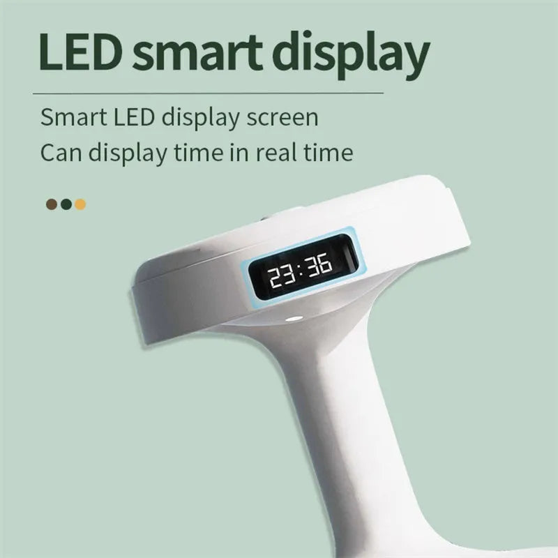 White columnar anti-gravity humidifier on a desk with LED clock display and visible mist.
