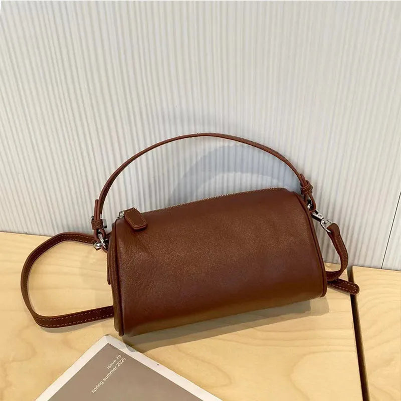 Genuine leather mobile phone crossbody bag with cylindrical design in six colour options showing sewing thread detailing