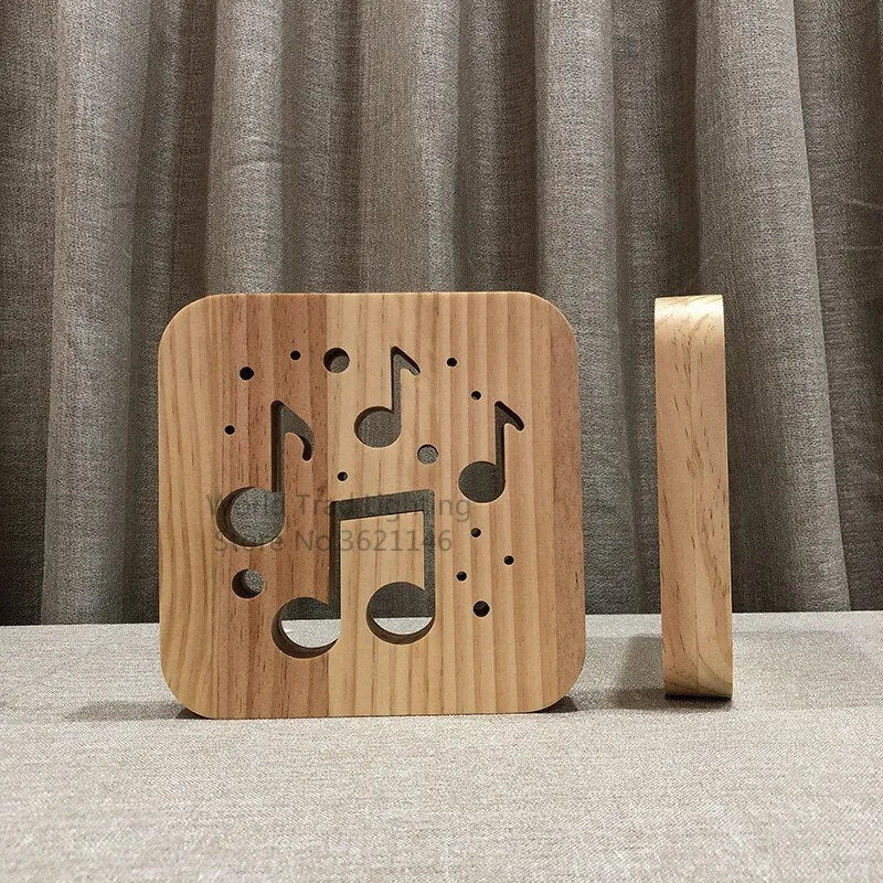Square pine wood USB lamp with 3D design emitting warm white light on a wooden desk.