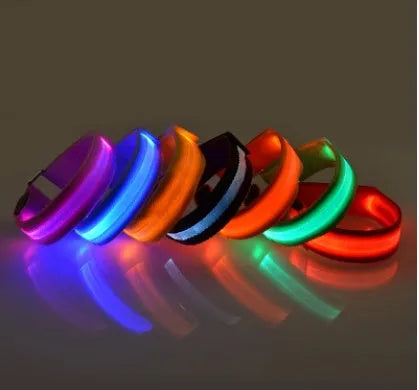 Illuminated arm band with LED lights on a black ribbon, adjustable, showing blue and red colours