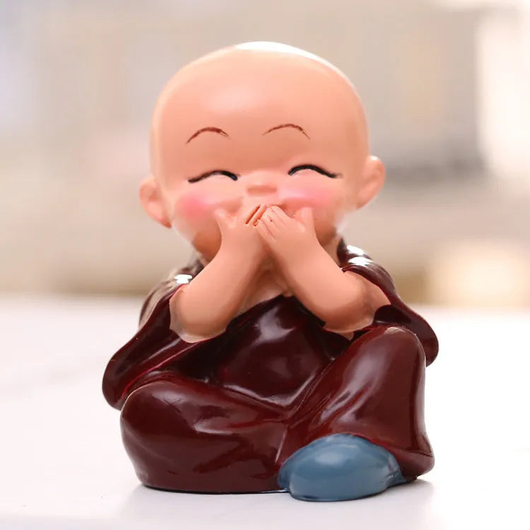 Set of four resin Buddha statue monk figurines in blue brown grey orange, each 4.7 by 3.5 by 5.5 cm
