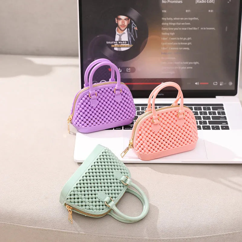 Translucent PVC jelly shell handbag with hollowed design and metal chain strap in apricot colour