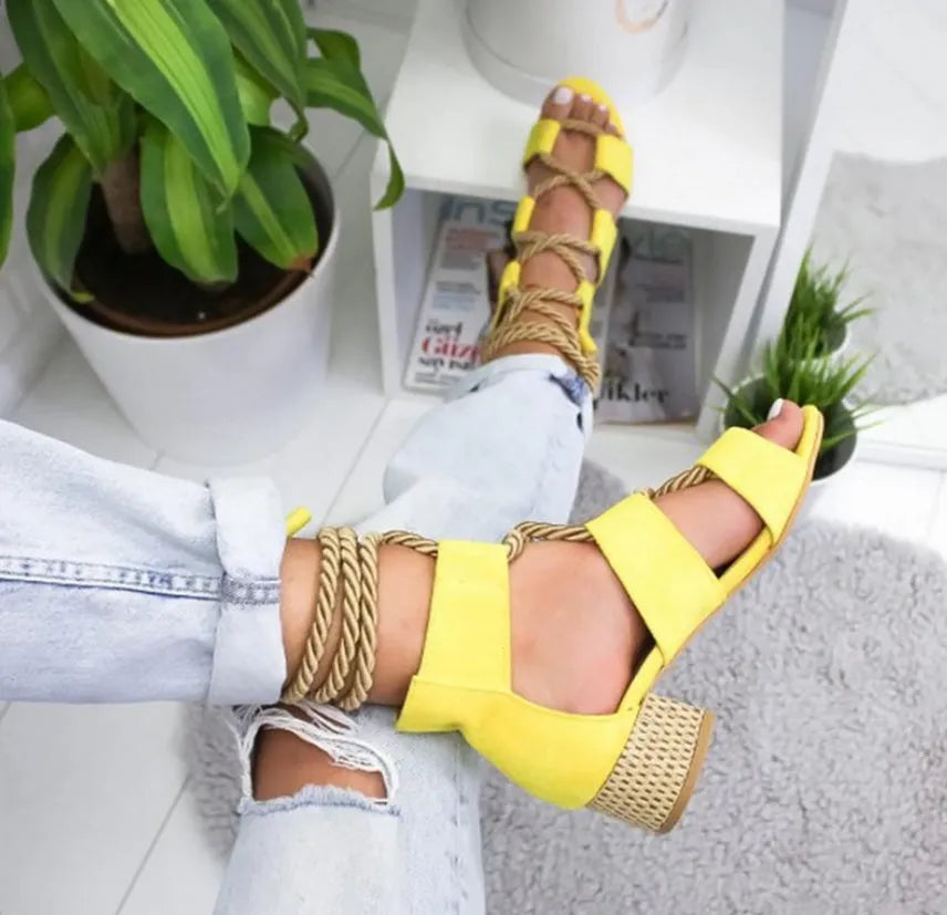 Women's beige suede sandals with a thick middle heel, fish mouth toe, and front ankle straps.