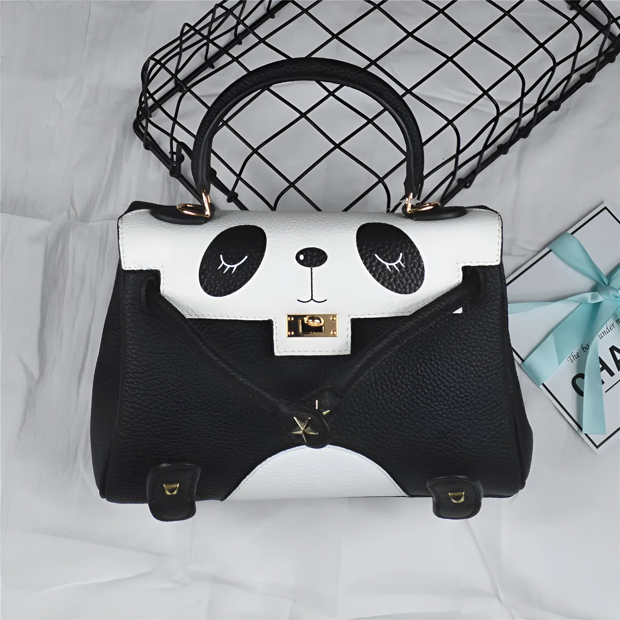 Panda print on a structured horizontal square leather handbag made from first-layer cowhide, shown in two size options.