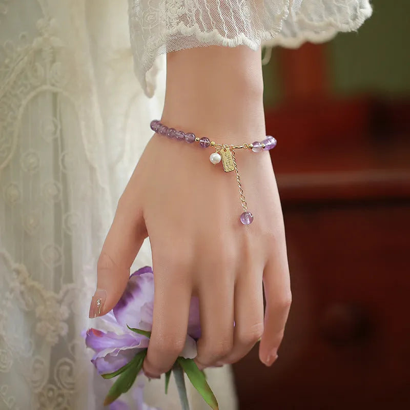 Women's lavender amethyst crystal bracelet with zodiac motif in dark and light colour options