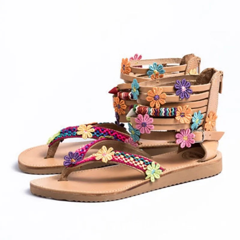 Ethnic style beaded petal sandals with floral design and round toe on a white background.
