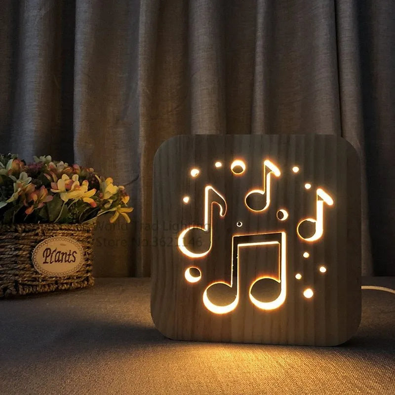Square pine wood USB lamp with 3D design emitting warm white light on a wooden desk.