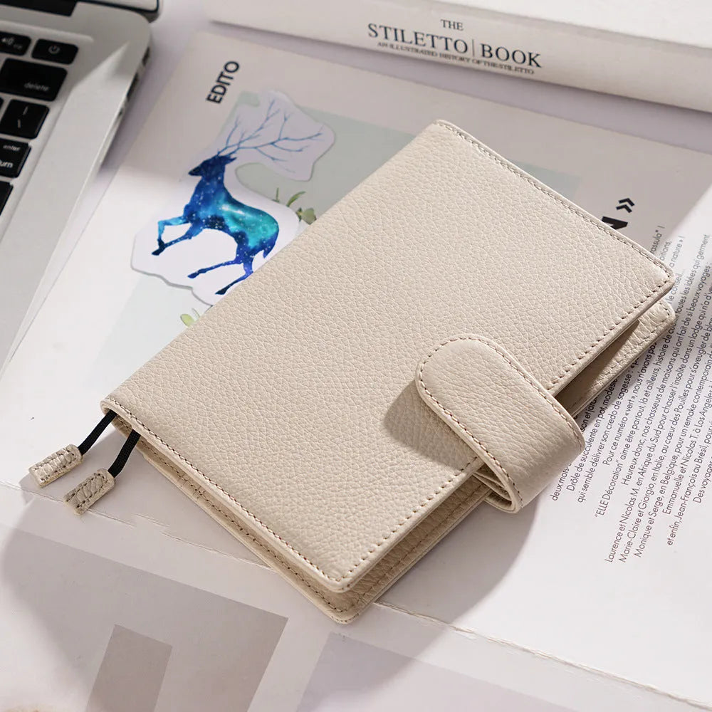 A6 leather notebook with lychee pattern cowhide cover showing loose-leaf binding in three colour options